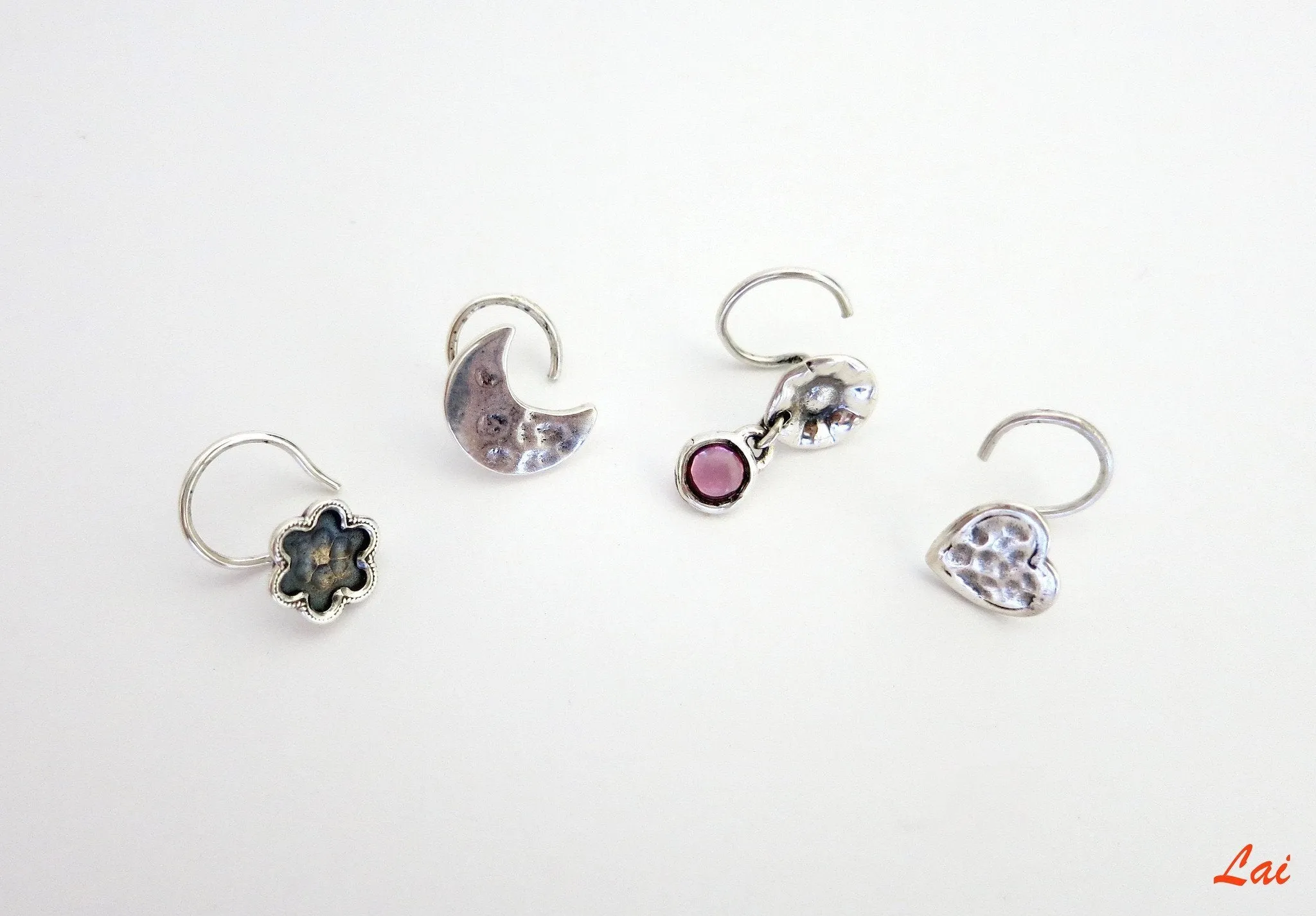 Quirky, hammer-finish, dangling pink-stone nose pin