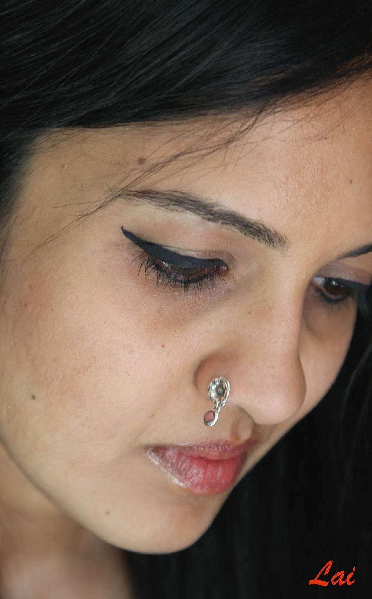 Quirky, hammer-finish, dangling pink-stone nose pin